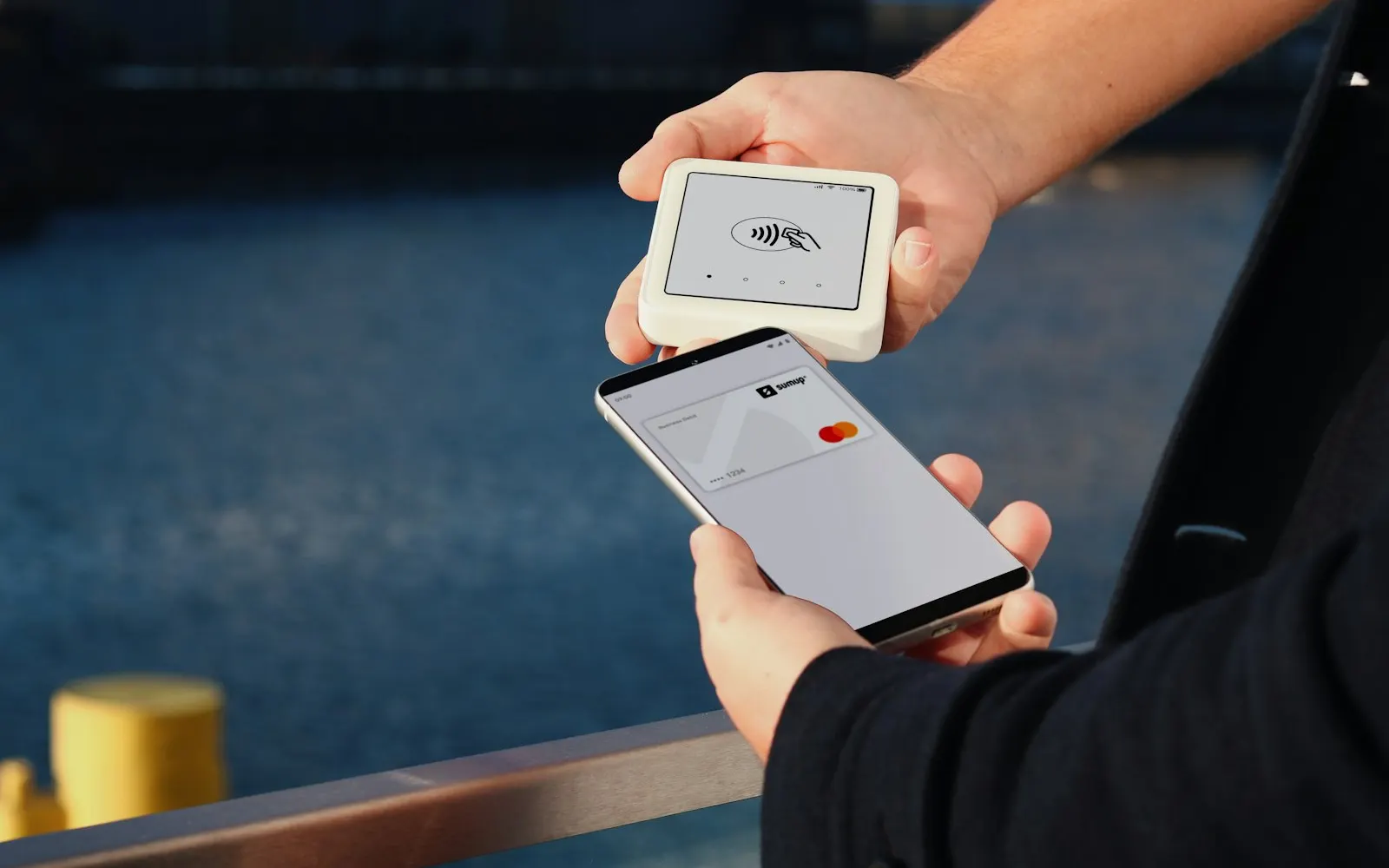 Business owner processing a contactless payment on a smartphone
