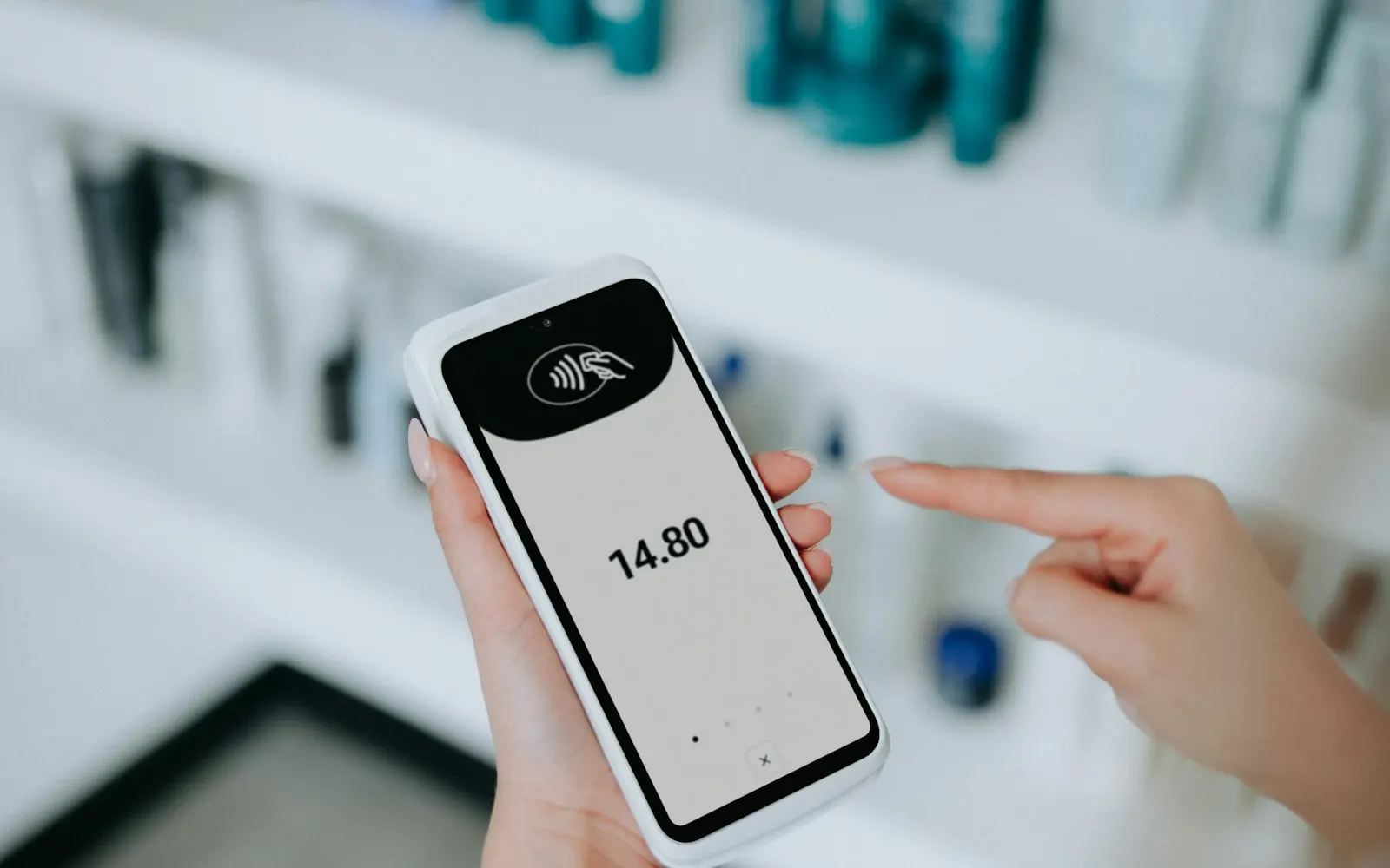 Person using a contactless card payment reader