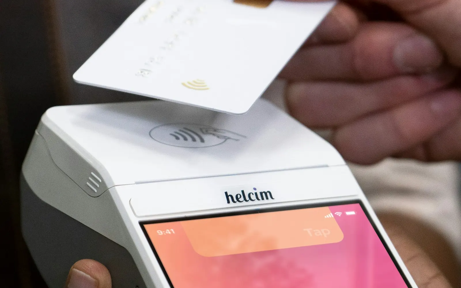 Smartphone held with a credit card for a currency exchange app