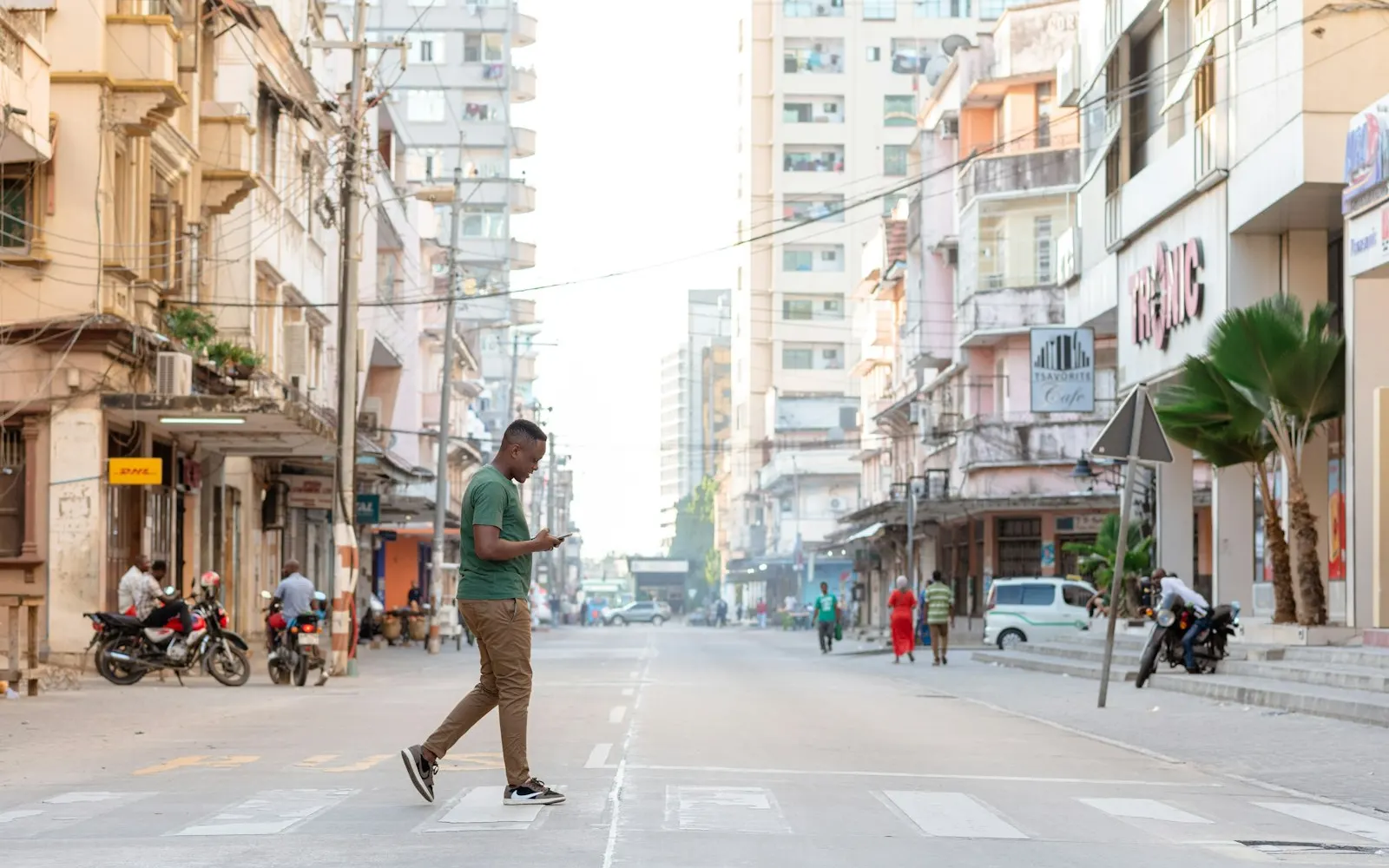 A person walking while using a smartphone for banking