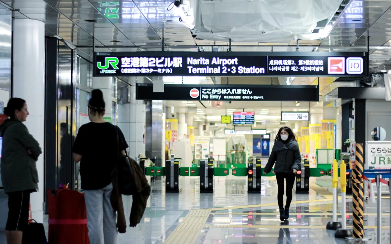 Travellers walking through a modern airport terminal