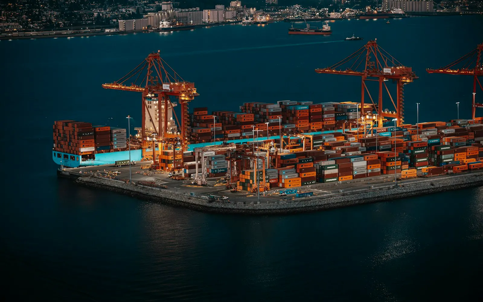 Container ship and cranes at a busy shipping port