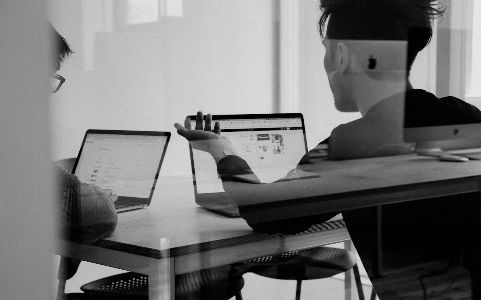 Business strategy meeting around a laptop